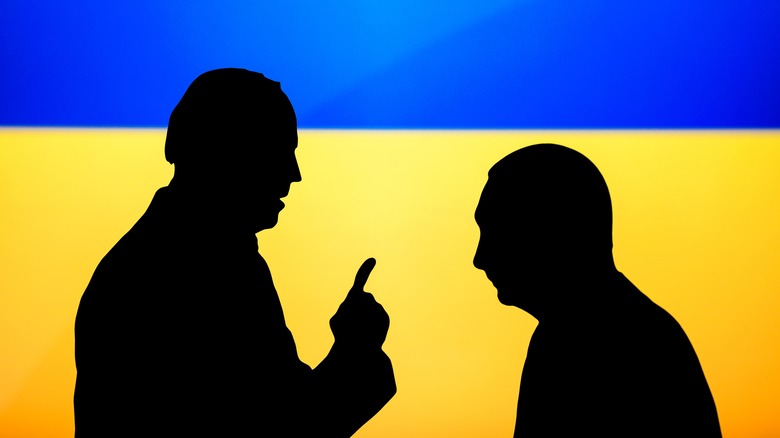 art of president joe biden and vladimir putin in silhouette against the Ukrainian flag