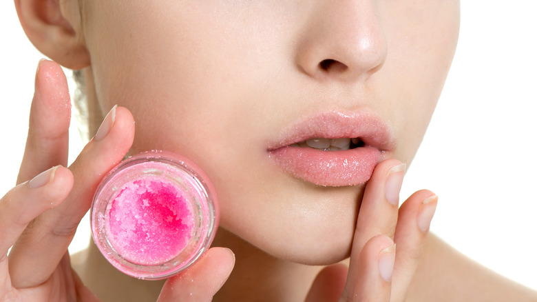 woman applying lip scrub