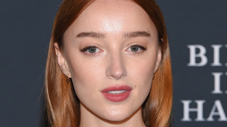 Phoebe Dynevor poses with copper hair