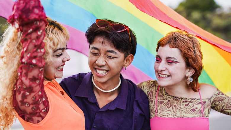 People holding up the pride flag