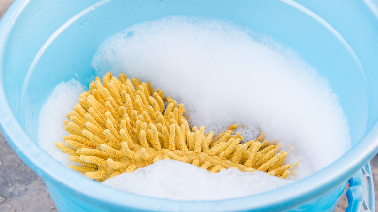 bucket with sponge and soap and water