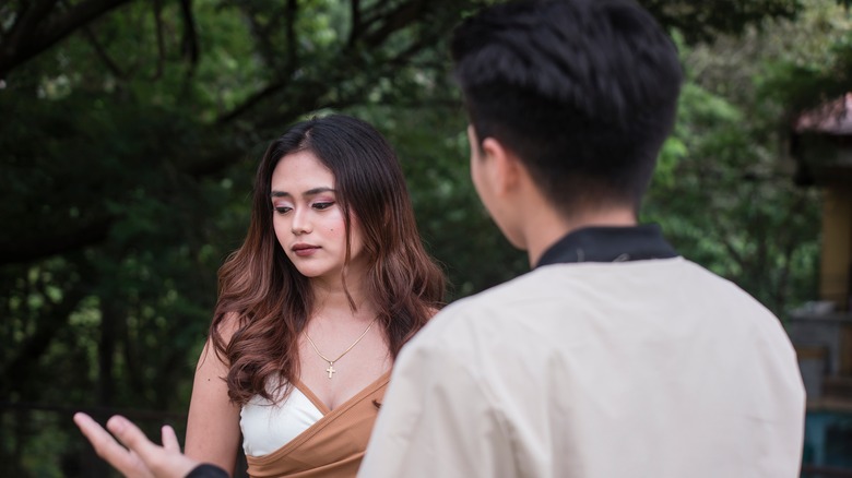 Man talking to frustrated woman