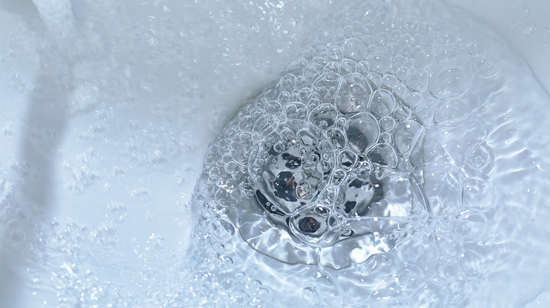 Water running down a kitchen sink drain 