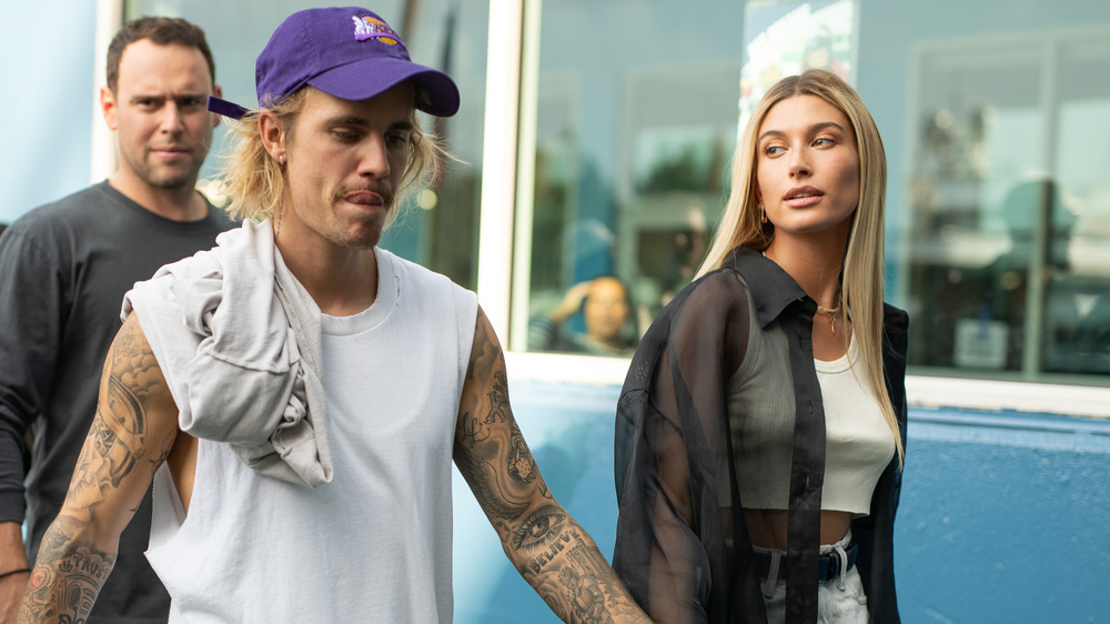 Hailey Bieber looking at Justin Bieber as they walk