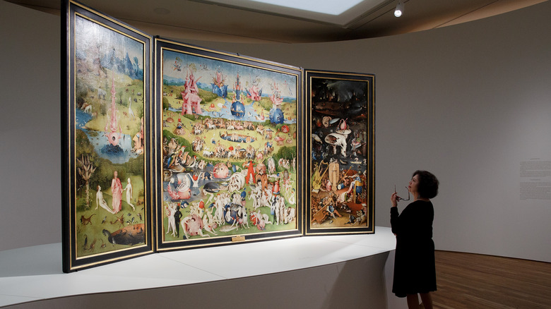 Woman views The Garden of Earthly Delights in Museo del Prado