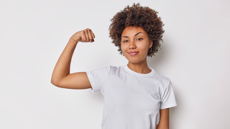 Confident woman flexing