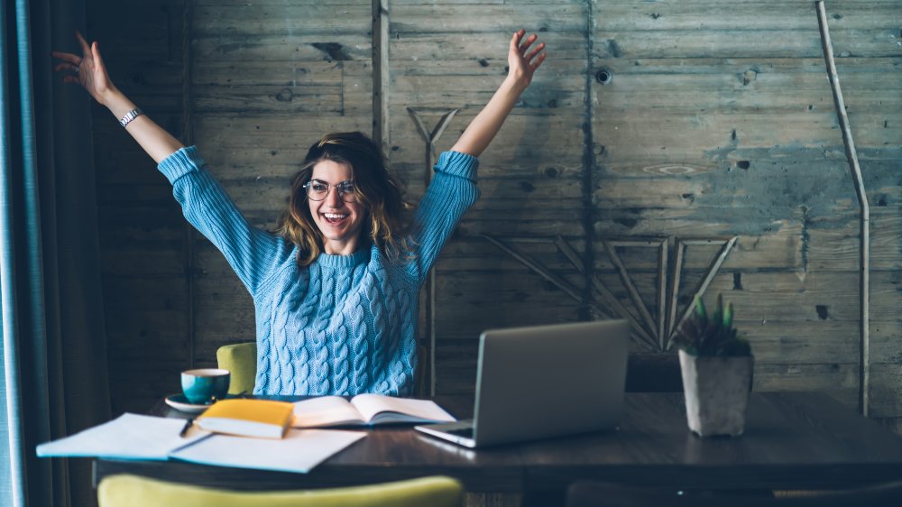 Woman with arms up in celebration