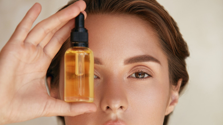 Woman holding face oil