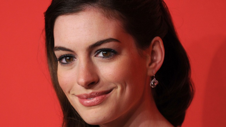 Anne Hathaway smiles at camera