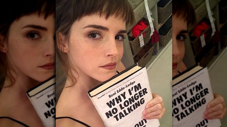 Emma Watson posing with a book on her Instagram