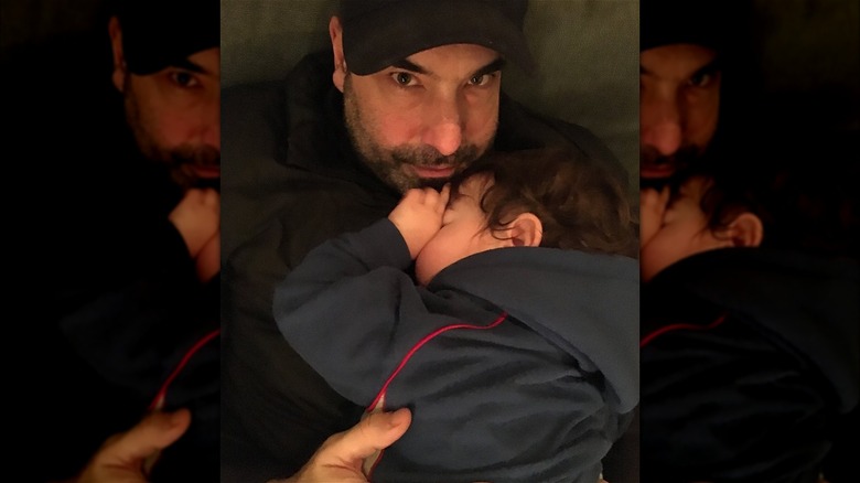 Rick Hoffman cuddling his young son