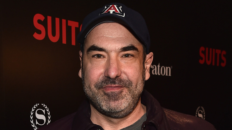 Rick Hoffman poses in baseball hat