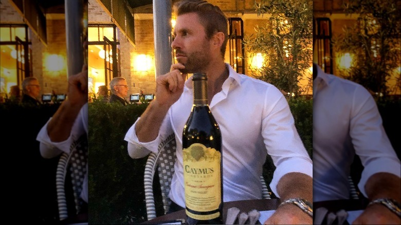 chase hoyt poses with wine bottle