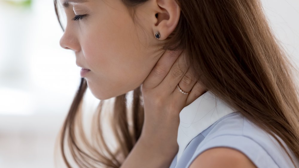 Woman hiding her throat 