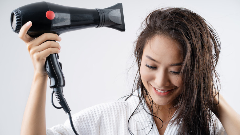 woman blowdrying hair