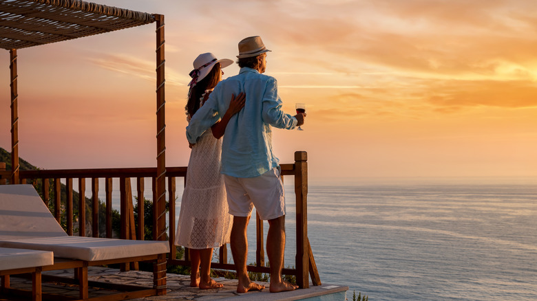 couple watching sunset on dock