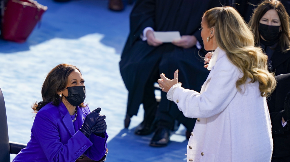 Jennifer Lopez and Kamala Harris smiling at each other