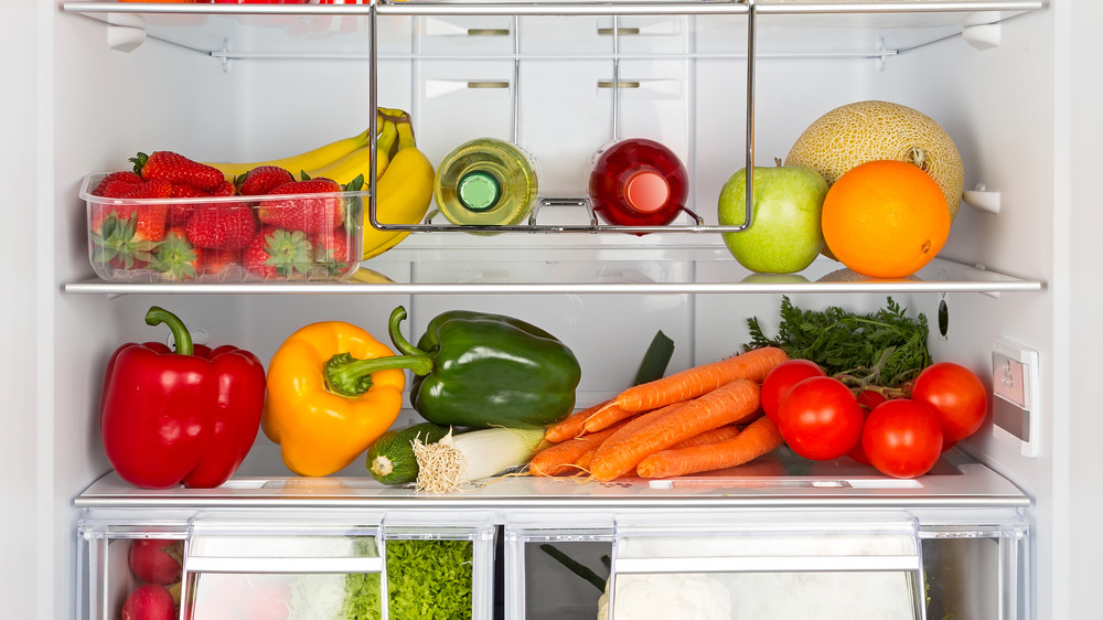 The inside of a fridge with fruit and vegetables