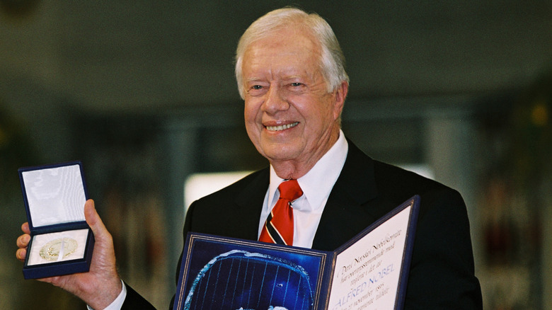 Jimmy Carter posing with Nobel Peace Prize