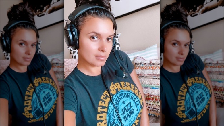 Joy Taylor wearing headphones makeup free