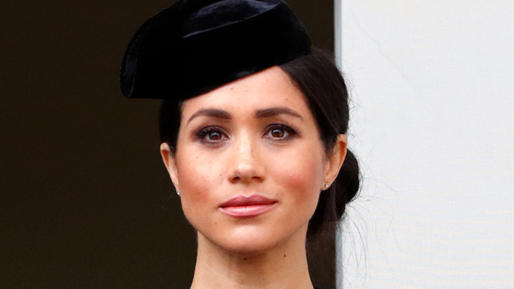 Meghan Markle looking serious in black