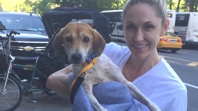 Lara Trump smiling, holding dog in blanket