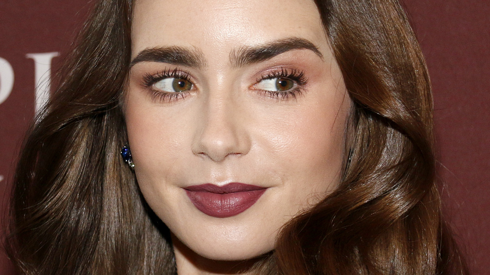 Make-up free Lily Collins poses in a Karl Largefeld T-shirt as she gets  ready for the Met Gala