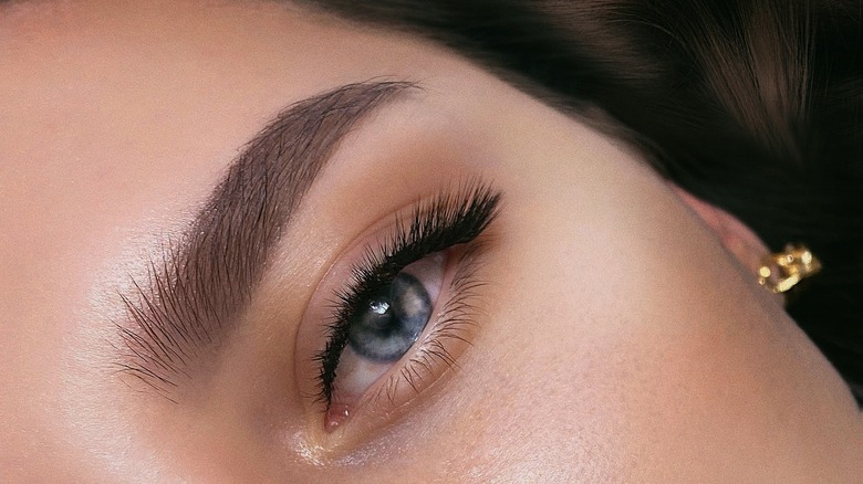 A woman wearing subtle liner with fake lashes at the end