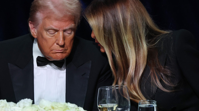 Melania Trump whispering to Donald Trump