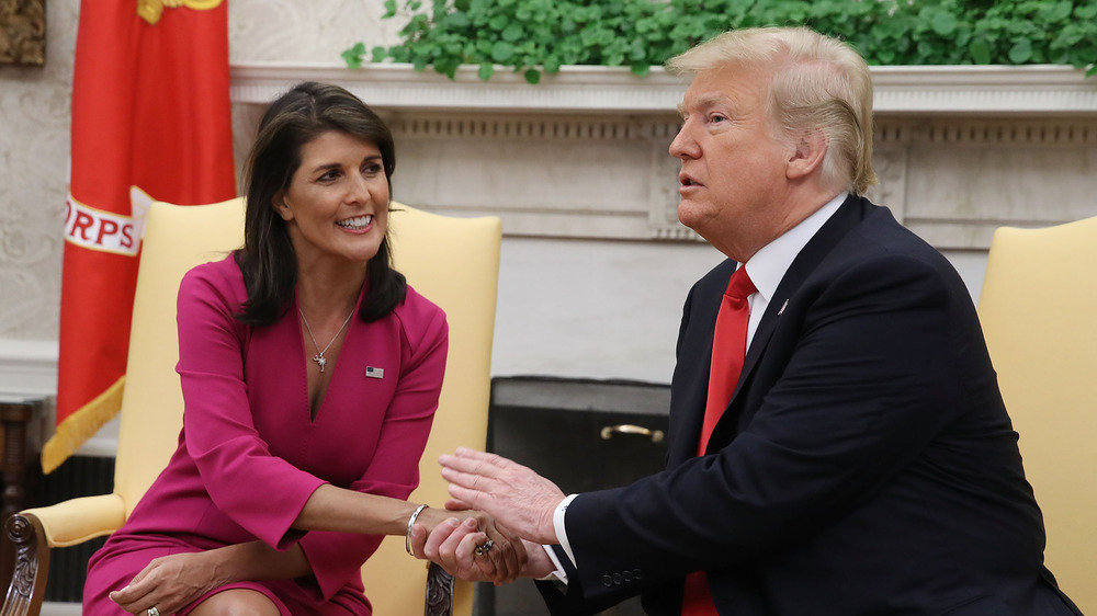 Nikki Haley and Donald Trump holding hands at the White House