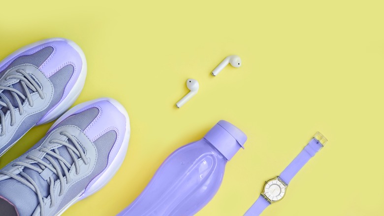 Periwinkle shoes, water bottle, and watch next to white airpods 