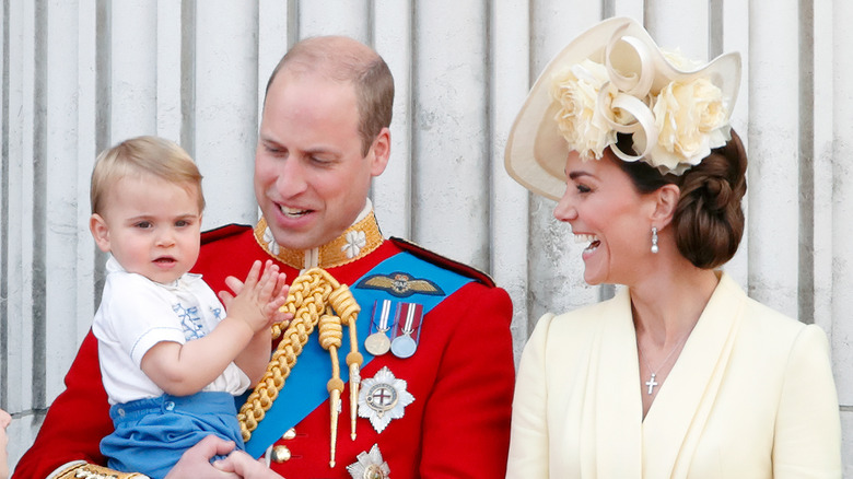 Prince William, Kate Middleton and their third child Prince Louis posing for a photo