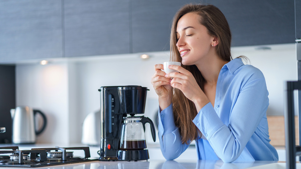 Woman holding cup of coffee