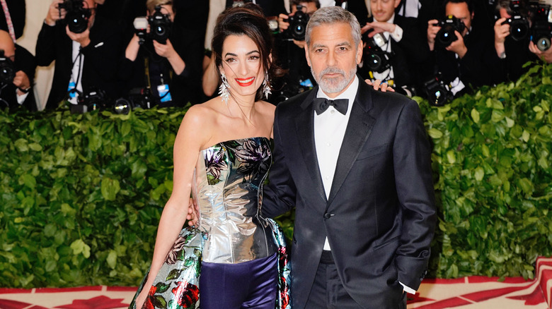 Amal and George Clooney posing together at the Met Gala