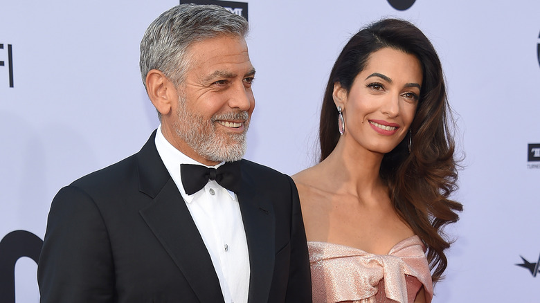 George and Amal Clooney laughing at an event