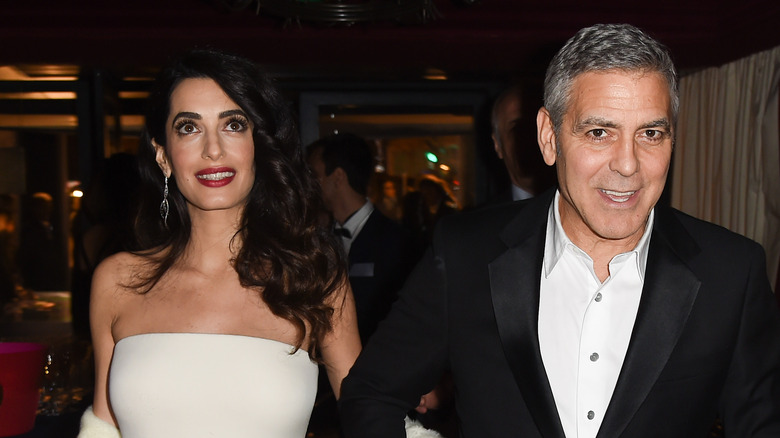 Amal Clooney and George Clooney walking