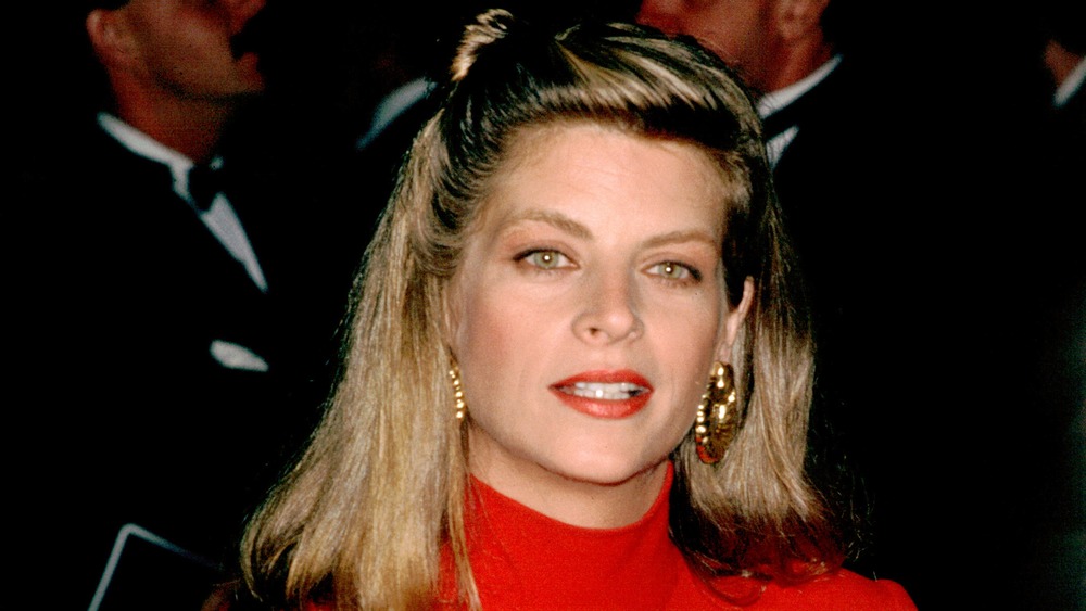 Kirstie Alley wearing a red top