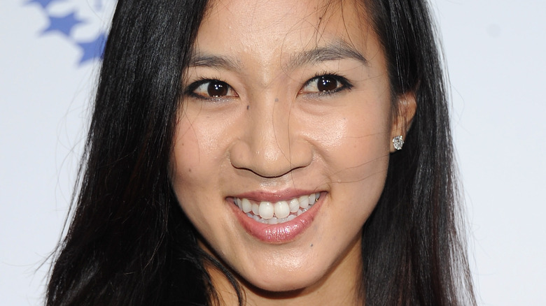 Michelle Kwan smiling, wearing stud earrings