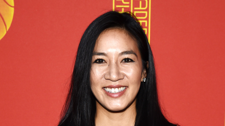 Michelle Kwan smiling by red background