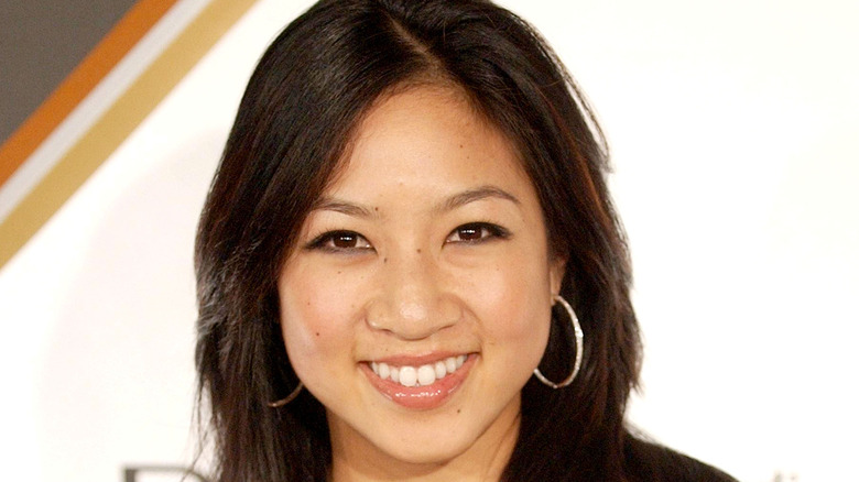 Michelle Kwan smiling, wearing hoops