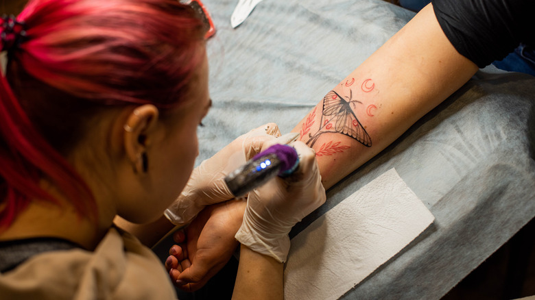 Arm being tattooed