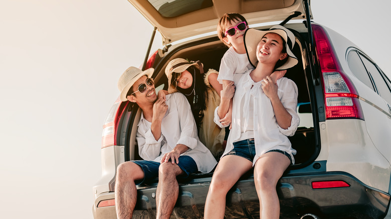 People sitting in the back of a vehicle. 