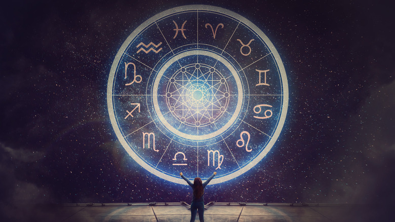 Woman standing in front of zodiac signs