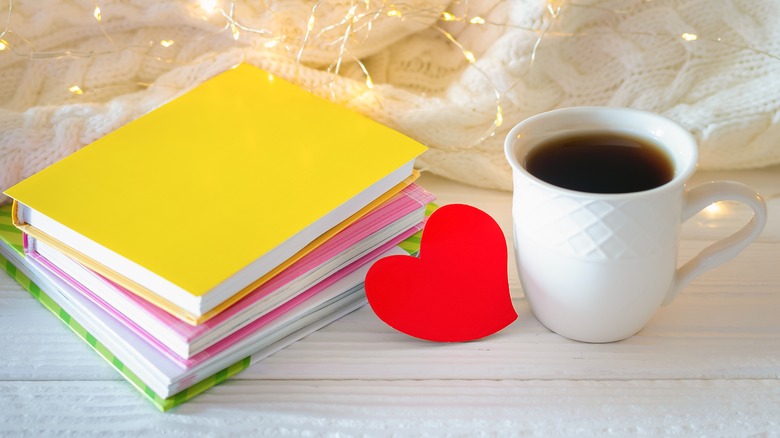 stack of books with coffee