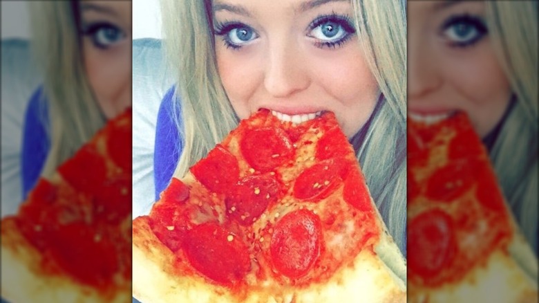 Tiffany Trump eating a slice of pepperoni pizza