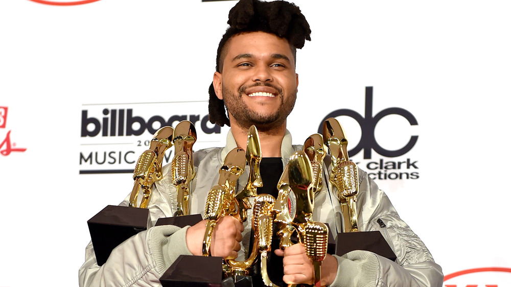 The Weeknd with arms full of Billboard Music Awards