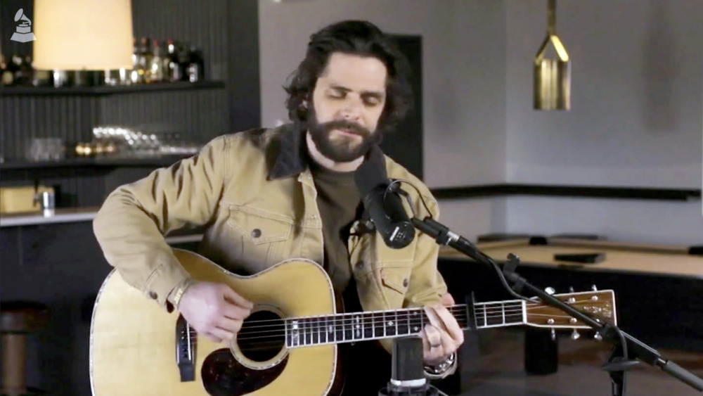 Thomas Rhett playing guitar and performing