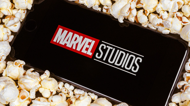 Cell phone with Marvel Studios logo surrounded by popcorn