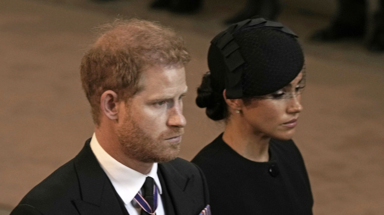 Meghan Markle and Prince Harry look despondent at the queen's funeral