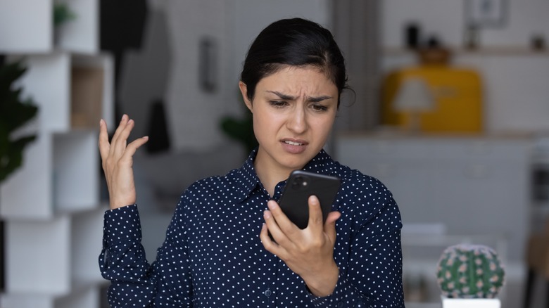 Person looking confused at phone